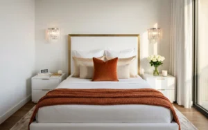 Calm bedroom with a neatly made white bed and soft bedside lighting